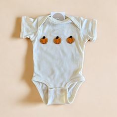 The cutest pumpkin baby outfit for this fall season! Makes the perfect outfit for fall baby photos, pumpkin patch and more. Available for the whole family also!  Please be mindful that we do not accept RETURNS / EXCHANGE / ORDER CANCELLATIONS in any way because this is made to order. We are also open for wholesale/bulk orders, kindly send us a message! Handmade in Chicago. Support small businesses. Shop small. ♡ Fitted White Onesie For Fall, Playful Cotton Onesie For Fall, Cotton Onesie For Playtime In Fall, Playful Fall Cotton Onesie, Cute White Onesie For Fall, White Cotton Onesie For Fall, Baby Pumpkin Patch Outfit, Baby Pumpkin Patch, Baby Pumpkin Outfit