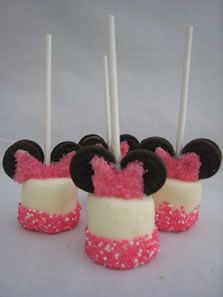 mickey mouse cupcakes are decorated with pink and black frosting, topped with minnie ears