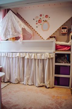 a child's room with a bed, dresser and shelf in it that has a canopy over the crib