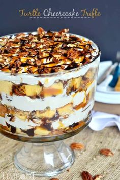 a trifle is sitting on a table with pecans