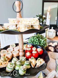 three tiered trays filled with different types of appetizers and food items