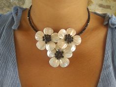 Beautiful handmade choker necklace made of mother of pearl, black onyx crystal and black beads. Nickel free, anti allergenic. Clasp: beads cross over the neck for a comfortable and steady experience. Measurements: total length open: 18.5 in/47 cm (choker/standard); beads width: 0.11 in/ 0.3 cm; flower diameter: 1.57 in / 4cm. Can be adjusted up or down the neck at will. Weight: approx. 45 grams (0.1 lbs). With dustbag. Free shipping ! Handmade Choker Necklace, Women Choker Necklace, Black And White Flower, Handmade Chokers, Onyx Crystal, Womens Chokers, Beaded Cross, Summer Necklace, Necklace Women