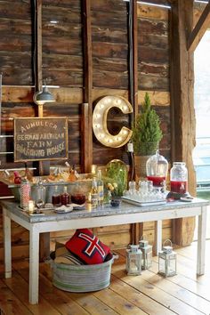 a table that has some food on it and lights hanging from the wall behind it