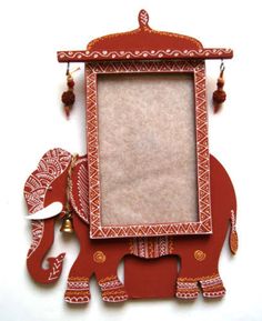 an elephant is standing in front of a red frame