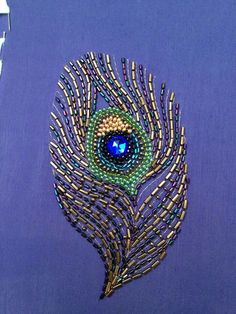 a brooch that is made to look like a peacock's tail