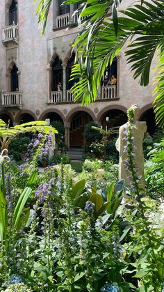 a building with lots of plants in front of it