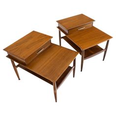 two small wooden tables with drawers on each side, one has a drawer open and the other is closed