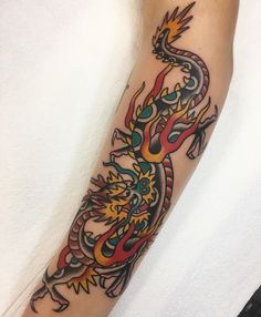 a colorful dragon tattoo on the arm