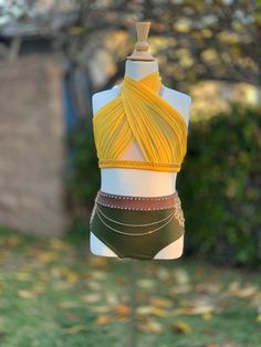 a mannequin wearing a yellow top and green panties with chains on it's sides