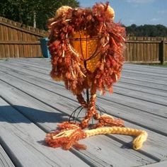 a light that is sitting on top of a wooden table next to a rope ball