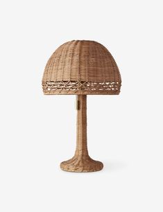 a wicker table lamp on a white background