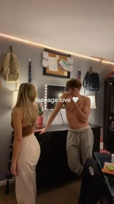 a man and woman standing in front of a counter with the words teenage love written on it