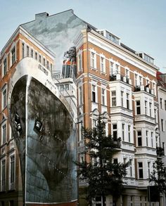 a large building with a giant boat painted on it's side in the city