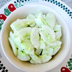 a white bowl filled with sliced apples on top of a table