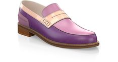 a pair of purple and pink shoes on top of a white surface with a wooden heel