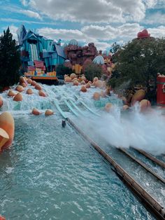 the water park is full of people and inflatable tubes that are coming out of the water