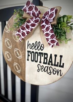 a door hanger with a giraffe print on it that says, hello football season