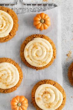 pumpkin cupcakes with cream cheese frosting and mini pumpkins on the side