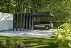 a car is parked in front of a building with black metal bars on it's sides