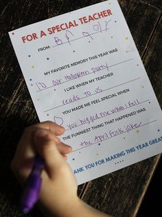 a child's hand writing on a special teacher letter