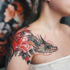 a woman with a dragon tattoo on her shoulder