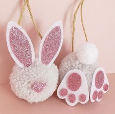 two white and pink bunny ears hanging from twine