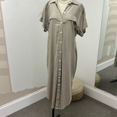 100% Linen. This Dress Can Be Worn Closed As A Short Dress, You Can Add A Belt To Synch The Waist. Or We Like To Style It Open Over Jeans With A Tank Like A Gilet. Beige Collared Beach Dress, Beige Button-up Midi Dress For Beach, Beige Button-up Midi Dress For Vacation, Neutral Dress With Button Closure For Daywear, Neutral Dresses With Button Closure For Daywear, Collared Linen Dress For Vacation, Neutral Daywear Dress With Buttons, Collared Linen Midi Dress For Day Out, Beige Collared Dress With Relaxed Fit