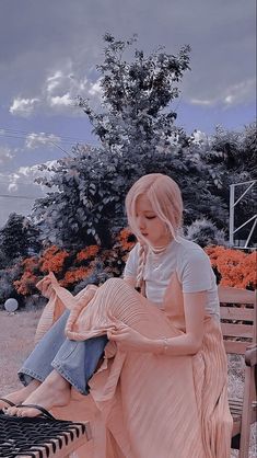 a woman sitting on a bench looking at her cell phone