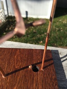 a wooden object with some metal rods sticking out of it