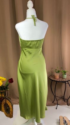 Midi dress Halter neck tie fastening Zipper fastening on the side 97% polyester 3% spandex Model is wearing a size small Color- green Dressy Strapless Maxi Dress For Spring, Fitted Mid-length Slip Dress For Spring, Fitted Mid-length Slip Dress For Party, Fitted Mid-length Spring Slip Dress, Green Maxi Dress For Cocktail, Green Mini Length Evening Dresses, Green Mini Dress For Garden Party, Spring Mid-length Maxi Dress For Night Out, Mid-length Slip Dress For Spring Parties