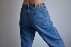 Vintage medium blue LEE men's jeans, from the 1990s Vintage men's high waist, LEE jeans with a leather patch on the back, zipper fly, classic five pocket style. Worn in the photos as women's jeans. Have been shortened, no longer have their original hem! Material - cotton Size - marked 34 x 33*, but fit smaller, like 31 (for a 31 inch waist) *This is the vintage size on the label, which does not correspond to contemporary standards, vintage denim tends to be smaller than contemporary denim. Pleas Vintage Short Length Blue Jeans, Vintage Blue Short Length Jeans, Vintage Blue Short-length Jeans, Vintage Straight Leg Denim Blue Pants, Vintage Lee Jeans, Original Hem, Lee Jeans, Cut Off Jeans, Leather Patches