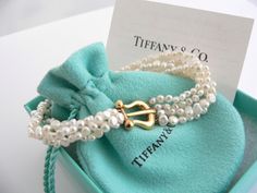 Overview:Every woman needs a strand of pearls ... but here's a piece that's more special than just any strand of pearls ... because it's made by Tiffany! :) Offered for sale is a wonderful Tiffany & Co. Picasso 18K Gold Buckle Multi Strand Pearl strand bracelet. Whether you are just starting your collection or are thinking of adding another piece, this one is perfect for you. This pearl bracelet is a gorgeous classic that will never go out of style. The piece is composed of 4 pearl strands with Luxury Pearl Bracelet With Charm, Luxury Pearl Chain Bracelet For Anniversary, Luxury Pearl Charm Bracelets For Gifts, Luxury Pearl Charm Bracelet As Gift, Luxury Pearl Charm Bracelet For Gift, Luxury Pearl Charm Bracelets As Gift, Luxury Akoya Pearl Bracelet With Pearl Chain, Luxury Pearl Drop Bracelet For Gift, Luxury Pearl Chain Bracelet