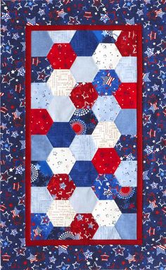 a quilt with red, white and blue hexagons on it's sides