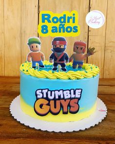 a birthday cake decorated with cartoon characters on it's top and the words rumble guys