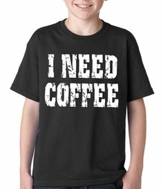 a young boy wearing a black t - shirt that says i need coffee