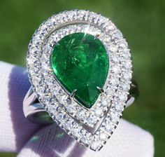 A Breathtakingly Striking  HANDMADE 14k White Gold Ring with Beautiful Pear Cut Tsavorite in Green color! The GEM is 5.24 CT and measures 13.22x9.73x5.34 mm! This Stone will take your breath away, especially on the sunlight! You will want to look at this stone endlessly. The mounting is a masterpiece! HANDMADE 14K White Gold Mounting (tested), that was is custom made to Accommodate this Beauty of a Gem in Prongs setting! Super FINE Workmanship on the Diamond prong  setting with 54 pcs Brilliant Full Cut Diamonds in GH color, SI1 clarity, totaling to approx 0.84 ct! Fabulous Braided Band and Diamond Gallery! The Entire Top's outline is 24.9x18.0 mm- HUGE. The Ring weights 8.5 g, nice and SOLID. Sits 6.7 mm off the top of the finger. Finger size 7 (Free Re-sizing with purchase). Center Stone Gia Certified Green Pear-shaped Diamond Ring, Gia Certified Green Pear-shaped Rings, Gia Certified Pear-shaped Green Emerald Ring, Gia Certified Green Gemstones Fine Jewelry, Gia Certified Green Gemstones For Anniversary, Gia Certified White Gold Tsavorite Rings, Gia Certified Fine Green Gemstones, Gia Certified Green Gemstones, Tsavorite Ring