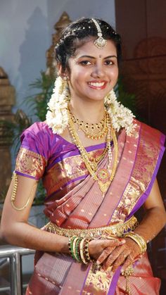 a woman in a sari is smiling for the camera