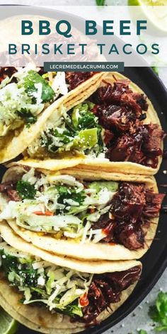 bbq beef tacos on a plate with limes and cilantro