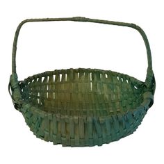 a green woven basket with handles on a white background for use as a decorative item