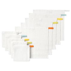 five pieces of white towels with yellow and blue trims on each side, one is folded