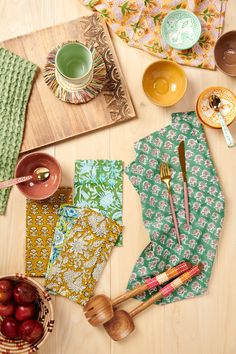 the table is covered with colorful napkins and utensils, along with other items