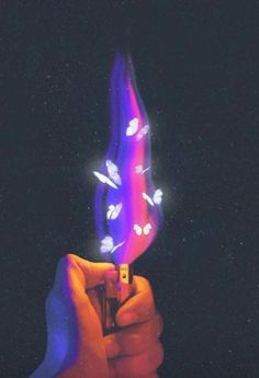 a person holding a lighter in their hand with purple and blue flames coming out of it