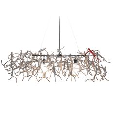 a chandelier made out of branches with red ribbons hanging from the bottom and two lights on each end