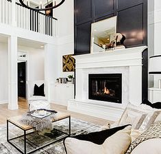 a living room filled with furniture and a fire place in the middle of a room