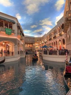 gondola ride in the middle of a canal inside a shopping mall with shops and restaurants