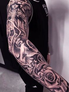 a man's arm with an angel and roses tattoo on the left arm, in black and white