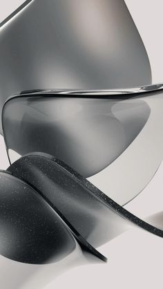 an abstract image of black and white shapes with silver highlights on the top, as well as grey background