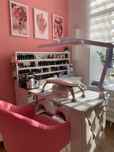 a pink chair sitting in front of a desk with bottles on it and other items