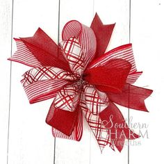 a red and white bow on a wooden surface