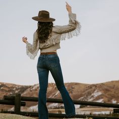 This cozy, wool-blend cable-knit cardigan sweater has a soft tan color, a front-button closure and stylish fringe accents at the back yoke and sleeves. Waist length, with longer, flowing sleeves, it offers easy elegance when worn with jeans, or a dash of bohemian flair when dressed up. Cable-Knit Fringe At Back Yoke And Sleeves Large Fold Down Collar Oversized Buttons 85% Acrylic, 15% Wool Imported Chic Fringe Cardigan, Cozy Long Sleeve Outerwear With Fringe, Chic Long Sleeve Fringe Cardigan, Winter Knit Sweater With Tassels, Casual Fall Sweater With Tassels, Cozy Fringe Cardigan For Fall, Knit Fringe Outerwear For Fall, Cozy Fringe Outerwear For Fall, Knit Outerwear With Fringe For Fall